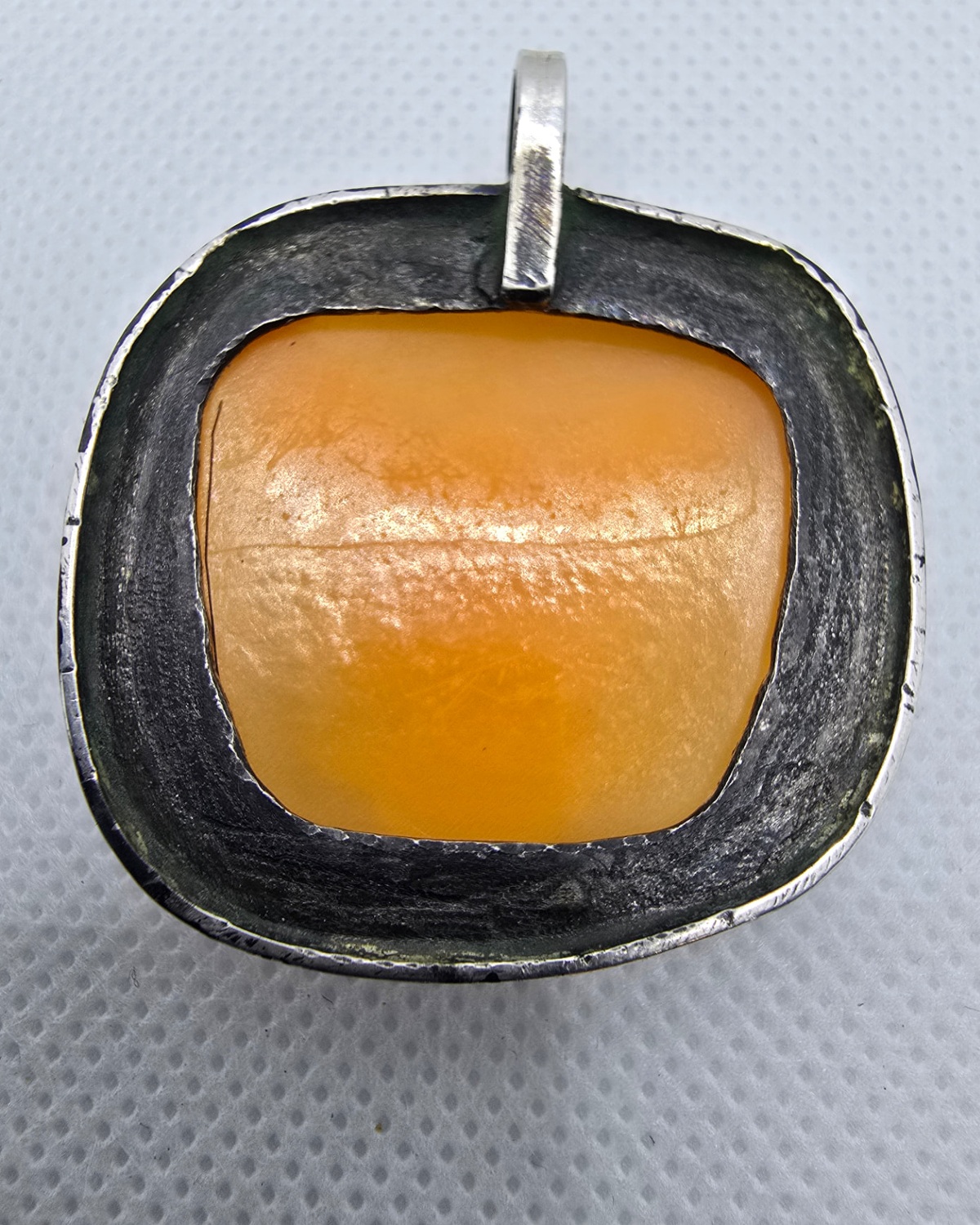 The Eagle — reverse showing the natural shell construction and the handcrafted silver mounting and bail