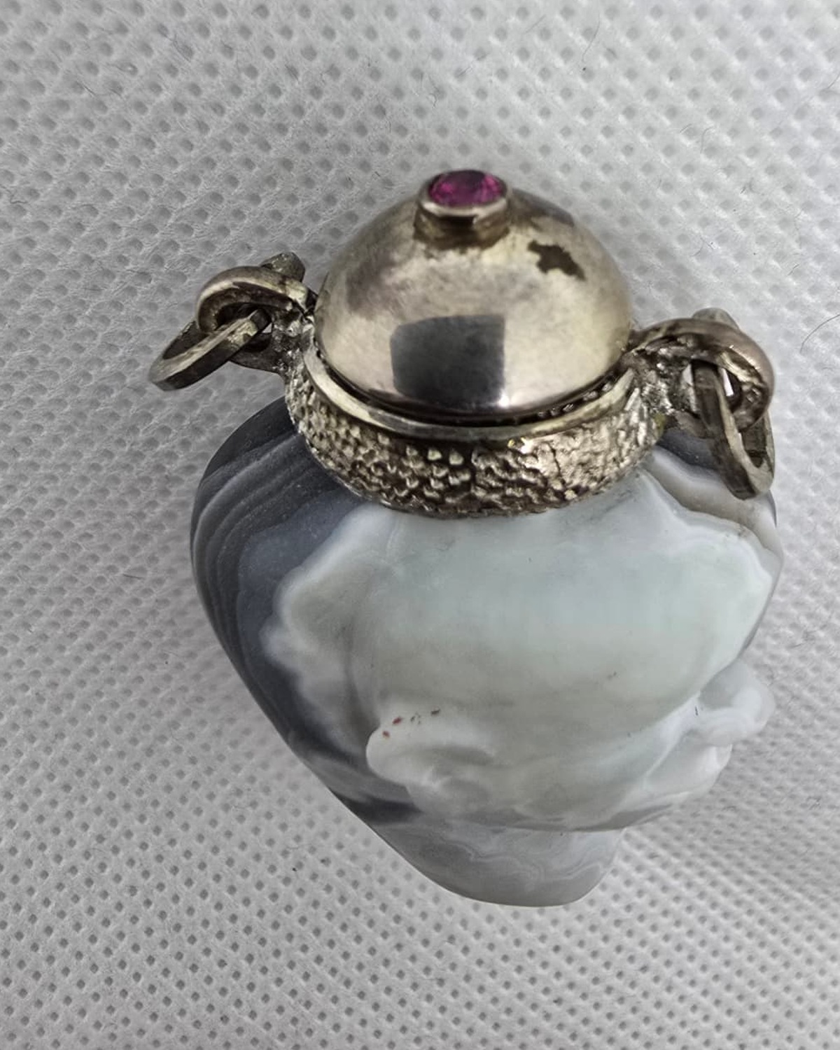 Hand-carved agate face vessel, neck and cabochon stopper detail