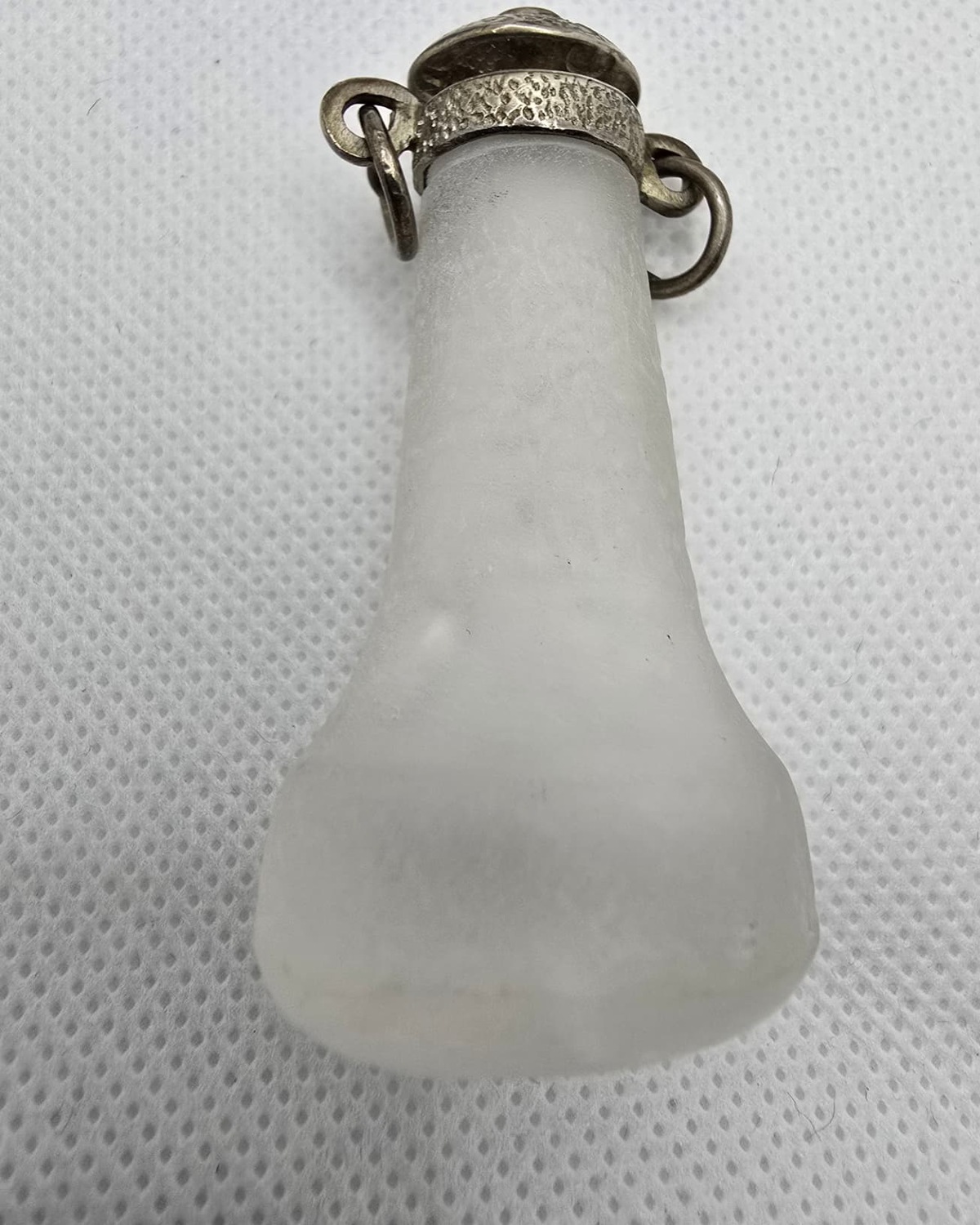 Frosted rock crystal flask with textured silver collar and rings, front view