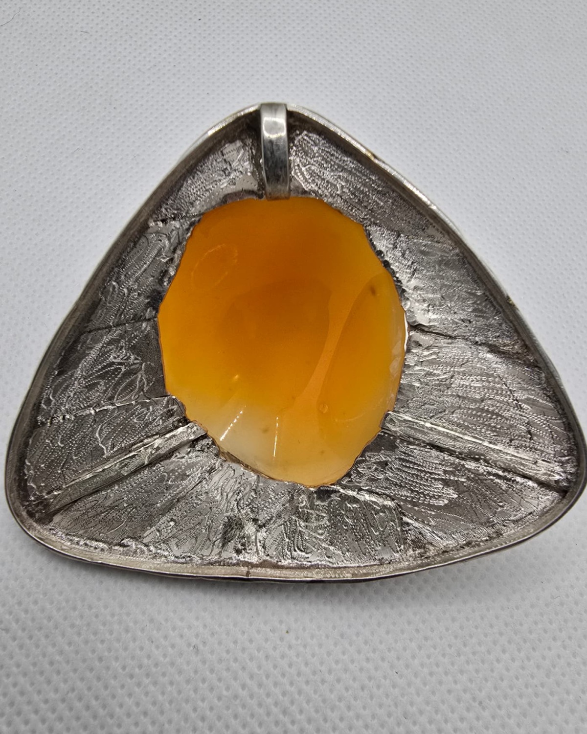Lionheart — reverse showing the natural warm orange-brown underside of the shell within the handmade silver structure and bail