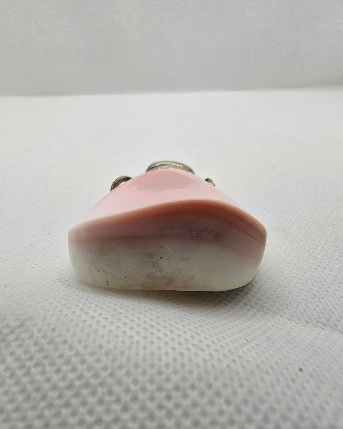 Pink and white banded agate vessel, profile showing banding