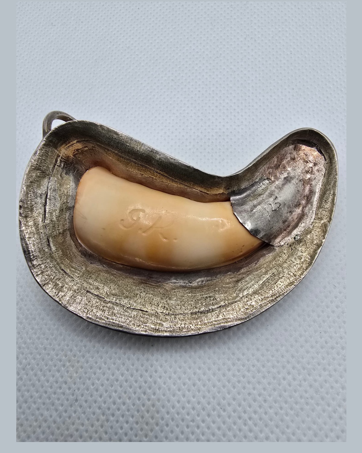 The Crescent — reverse showing the golden-orange natural sea shell, the carved GK monogram and the handmade crescent surround with bail