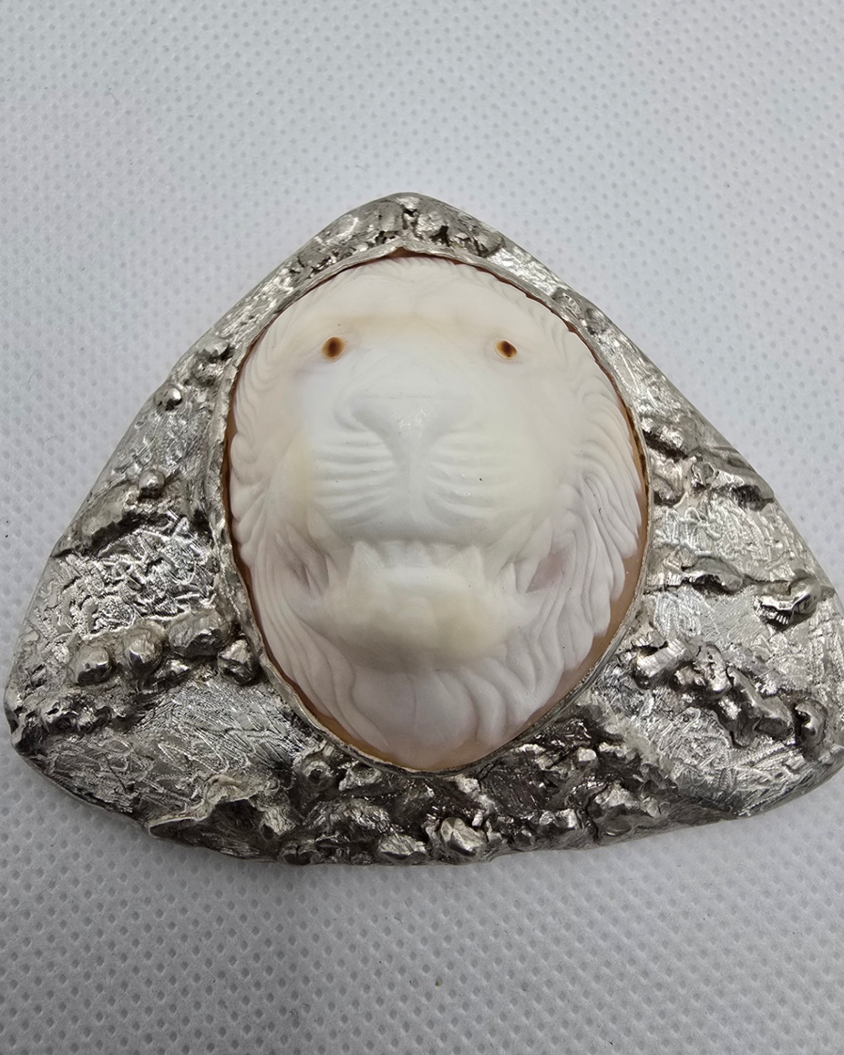 Lionheart — lion's head hand-carved in deep relief from natural shell within an expansive rugged handmade triangular silver setting