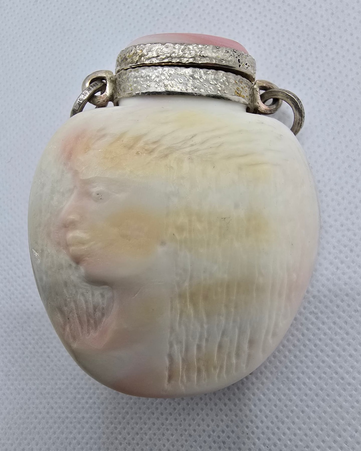 Pink sea shell vessel with silver mount, front view