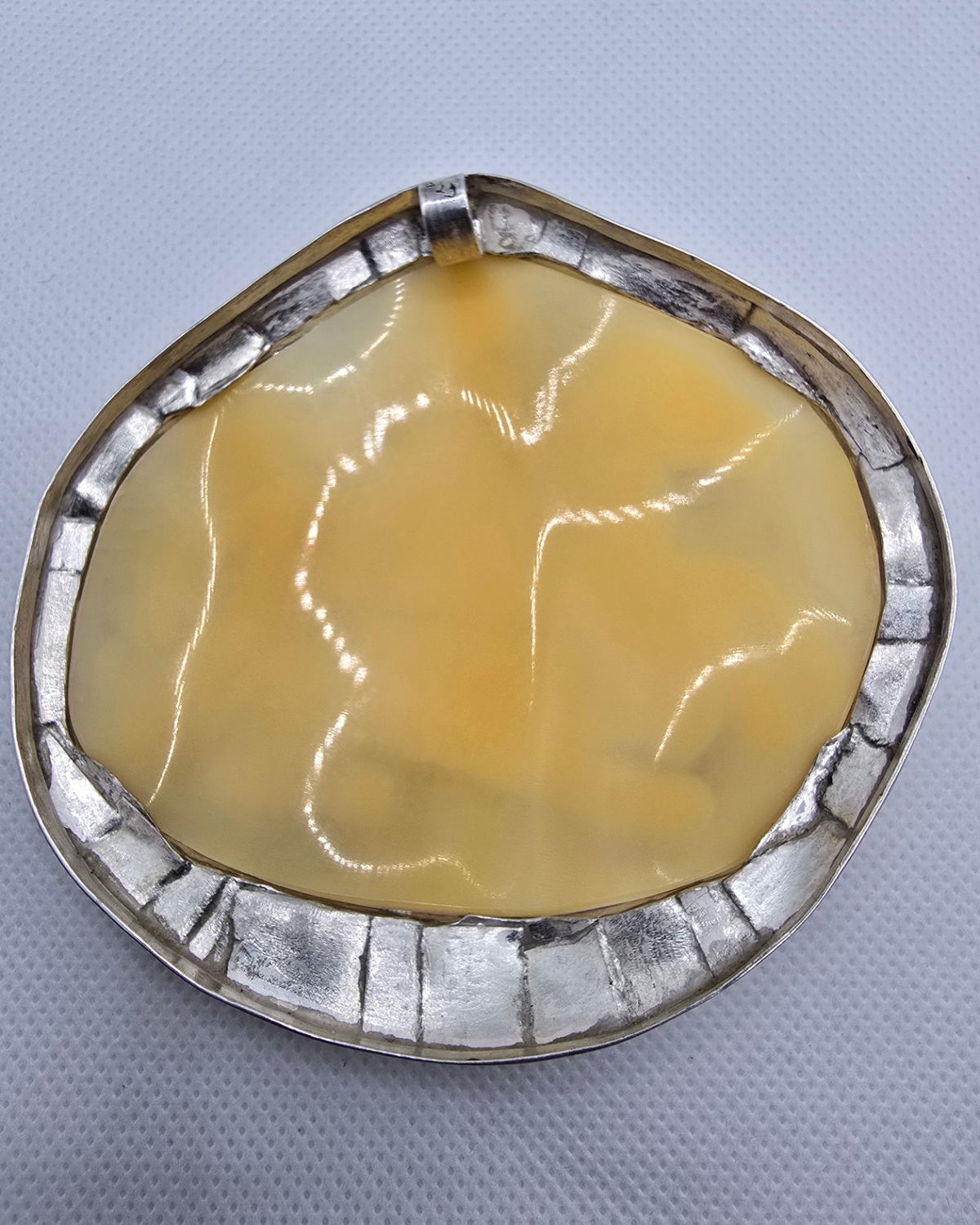 The Hunt — reverse showing the golden natural sea shell within the handmade silver setting