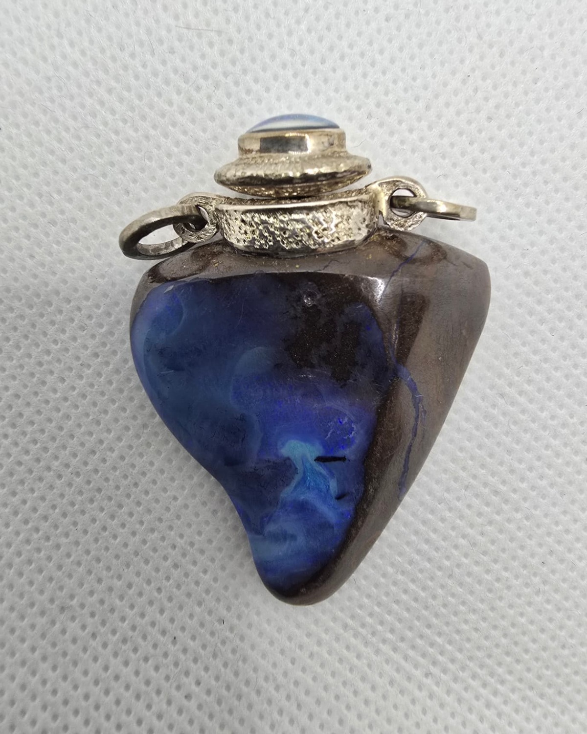 Blue opal heart-shaped vessel with silver mount, front view