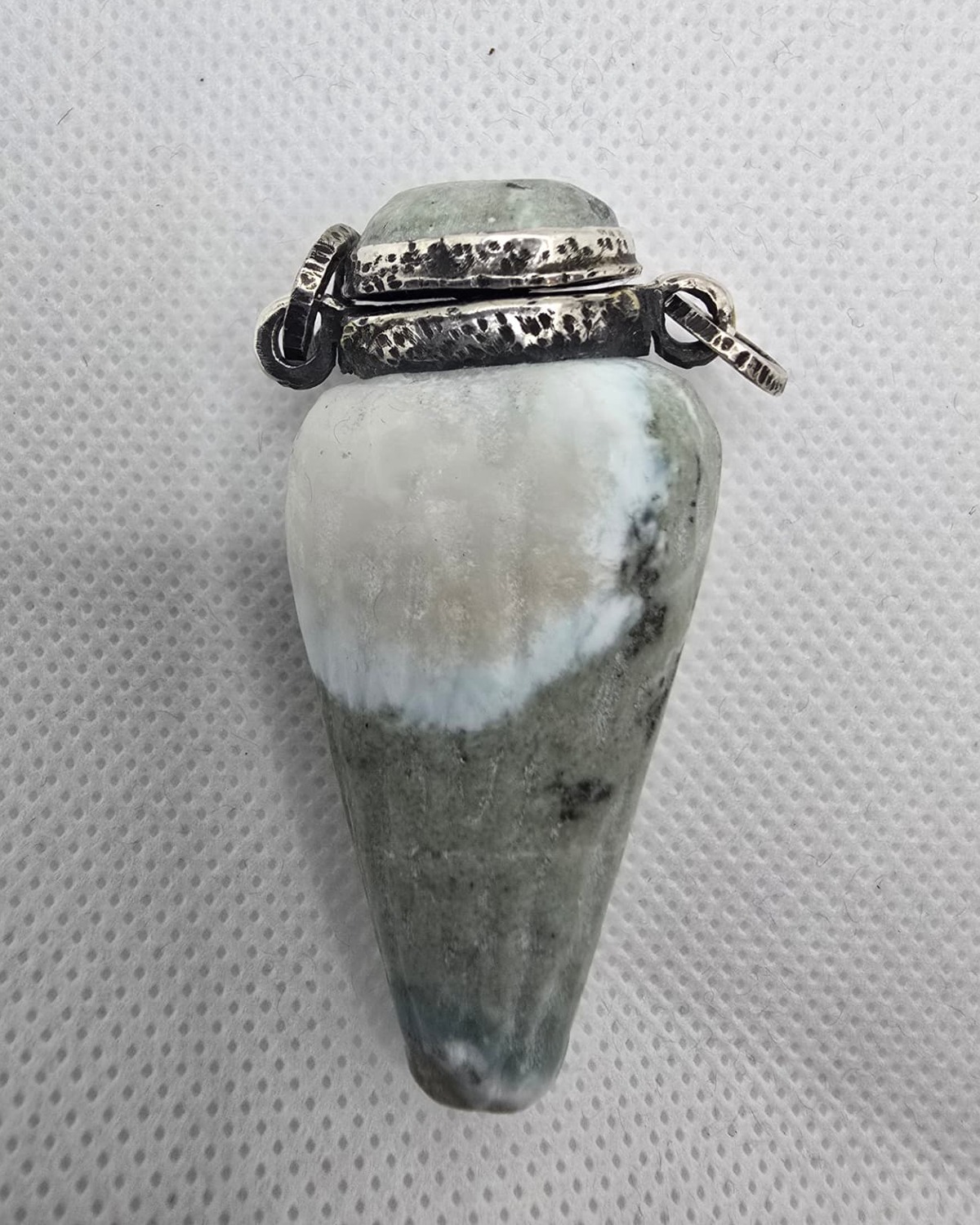 Hand-carved green and white stone vessel, reverse view