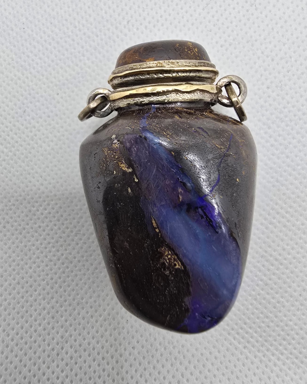 Dark boulder opal vessel with silver mount, front view