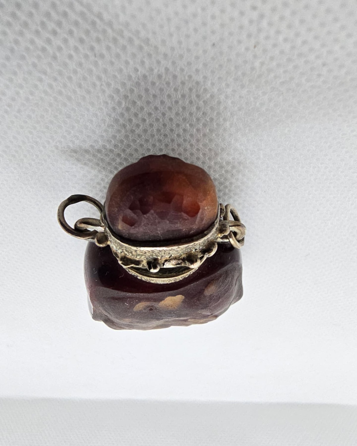 Red amber vessel seen from above, stopper and collar detail