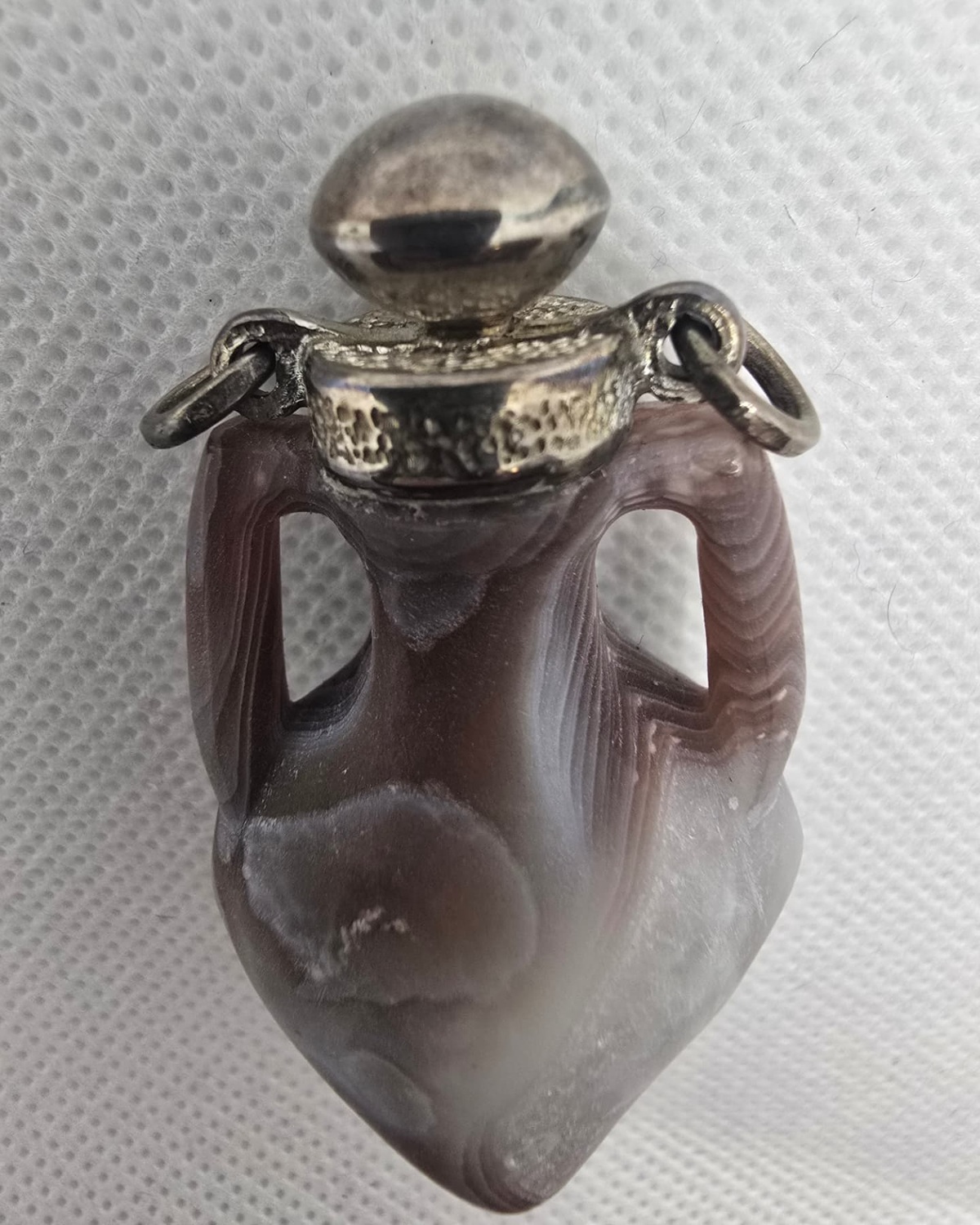 Banded agate amphora with pierced handles and silver stopper, front view