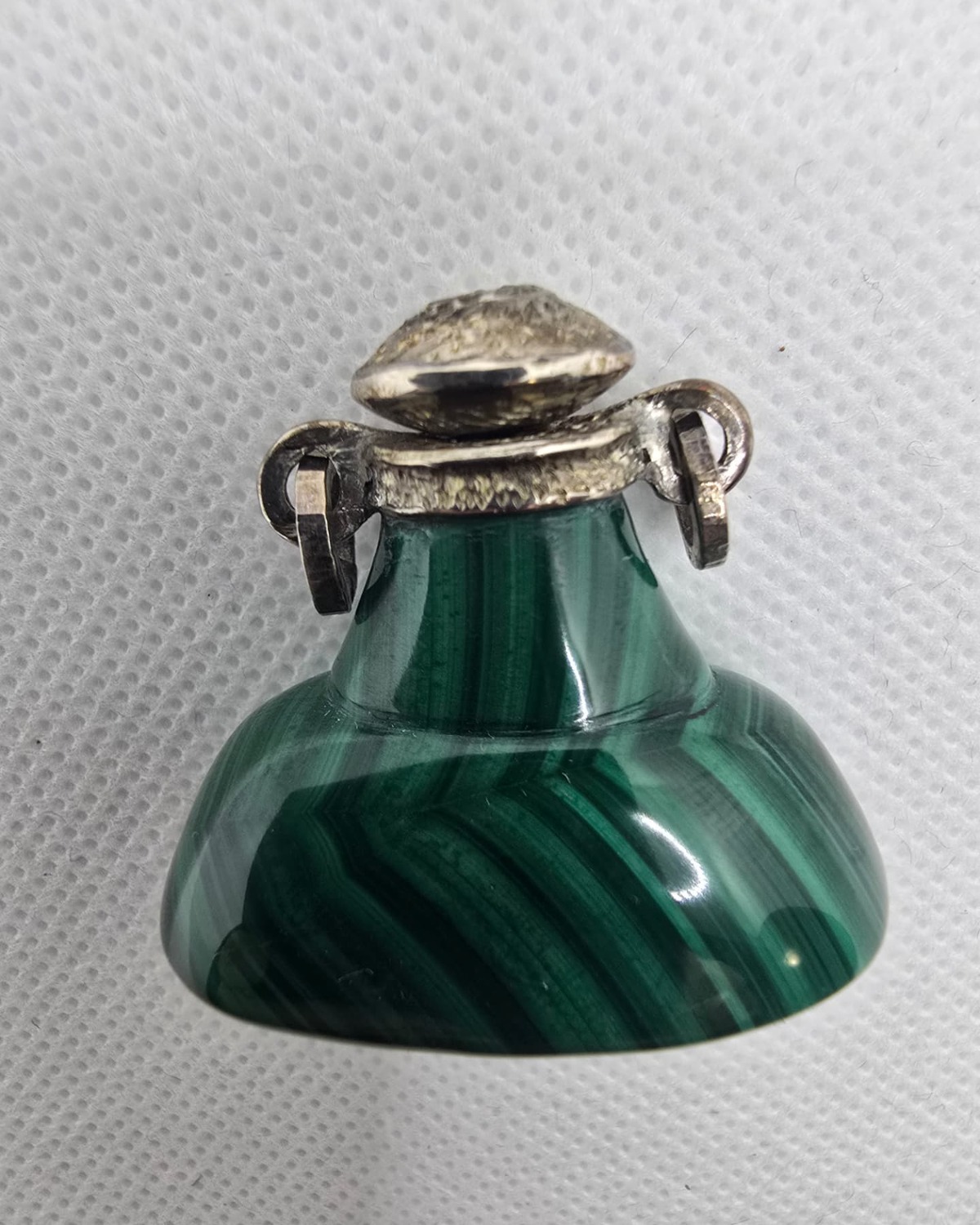 Banded malachite vessel with silver collar and stopper, front view