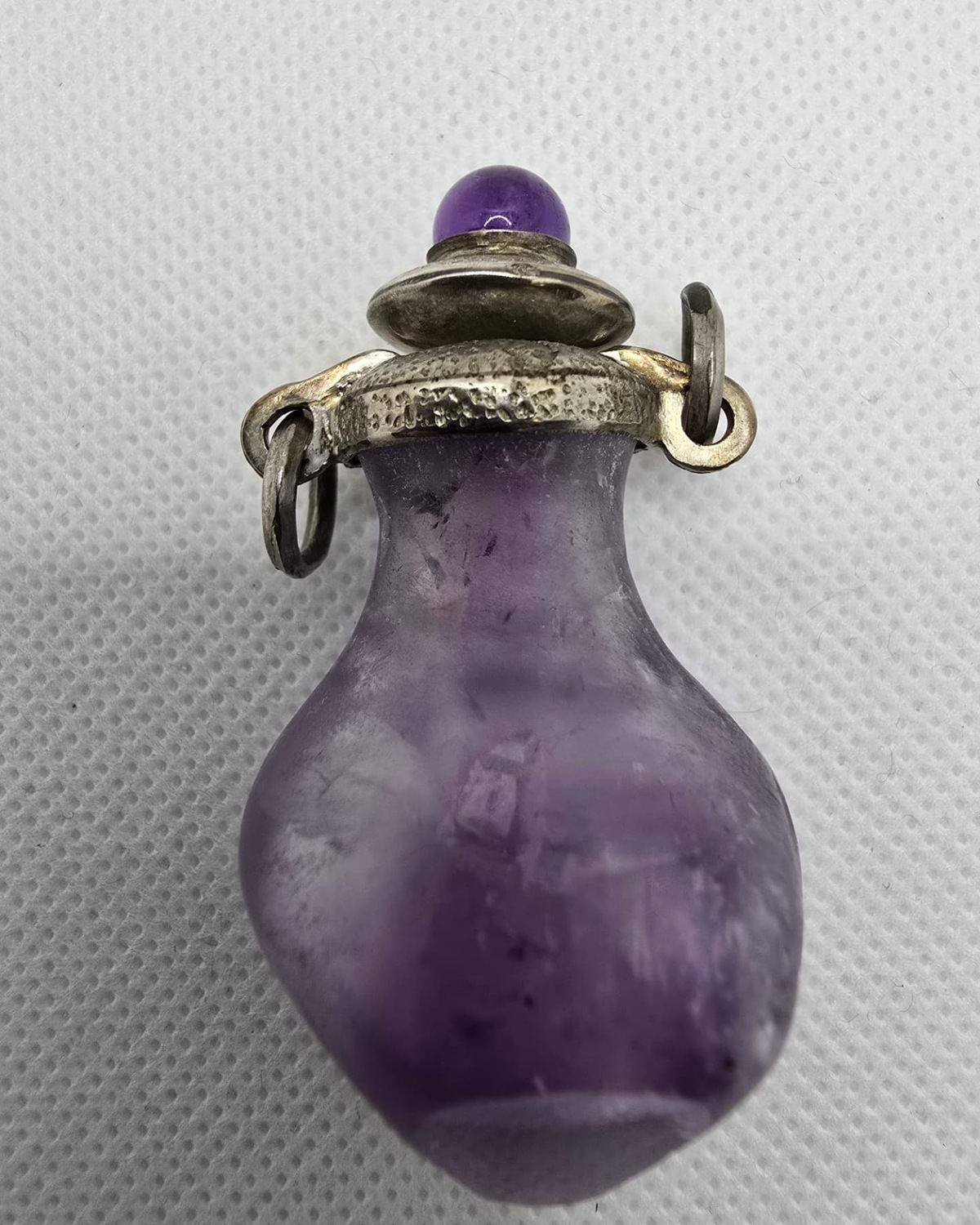 Frosted amethyst amphora with silver collar and amethyst cabochon stopper, front view