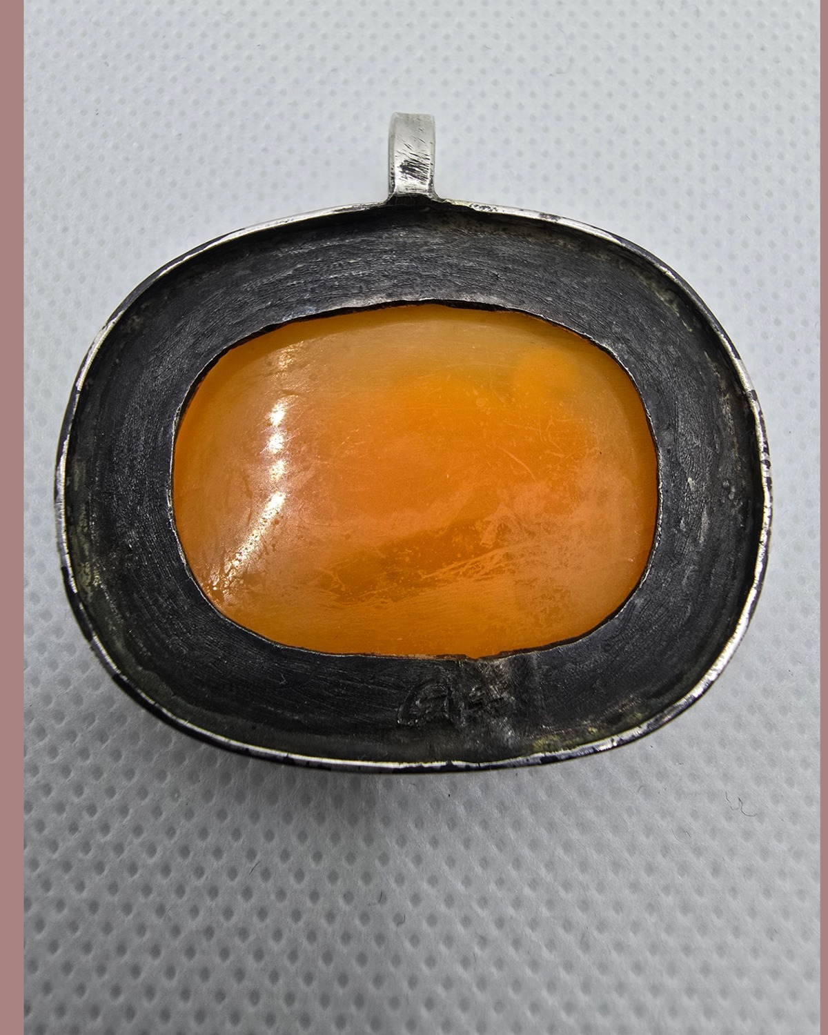 The Elephant of Strength — reverse showing the exposed warm natural sea shell within the handmade darkened silver frame and bail