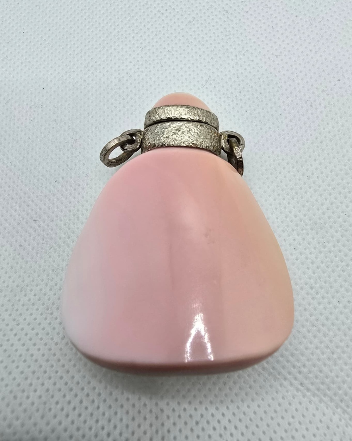 Pink and white banded agate vessel with silver collar, reverse view