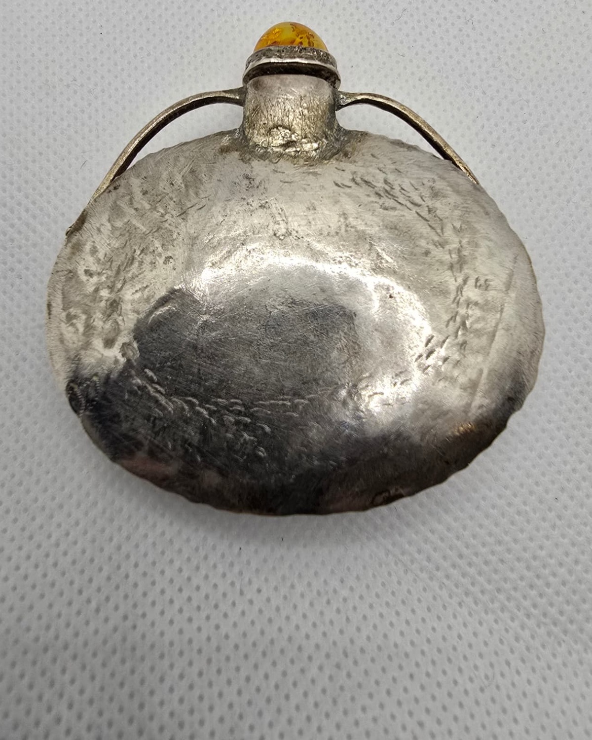 Amber and silver flask, reverse view showing amber translucency