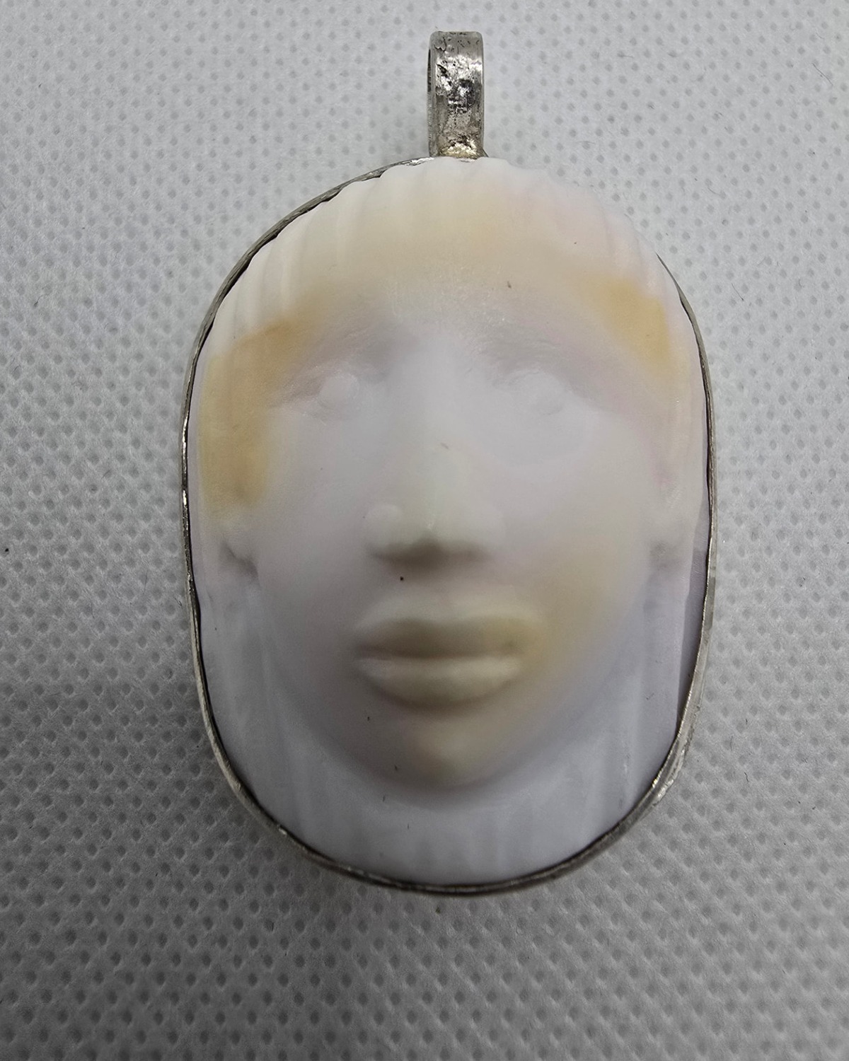 Serenity — hand-carved sea shell cameo, front view of the sculpted face in its handmade silver setting