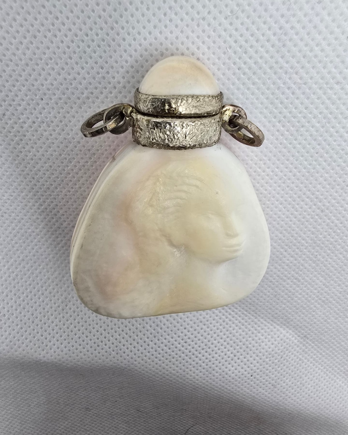 Carved mother-of-pearl shell vessel with silver mounts, alternate view