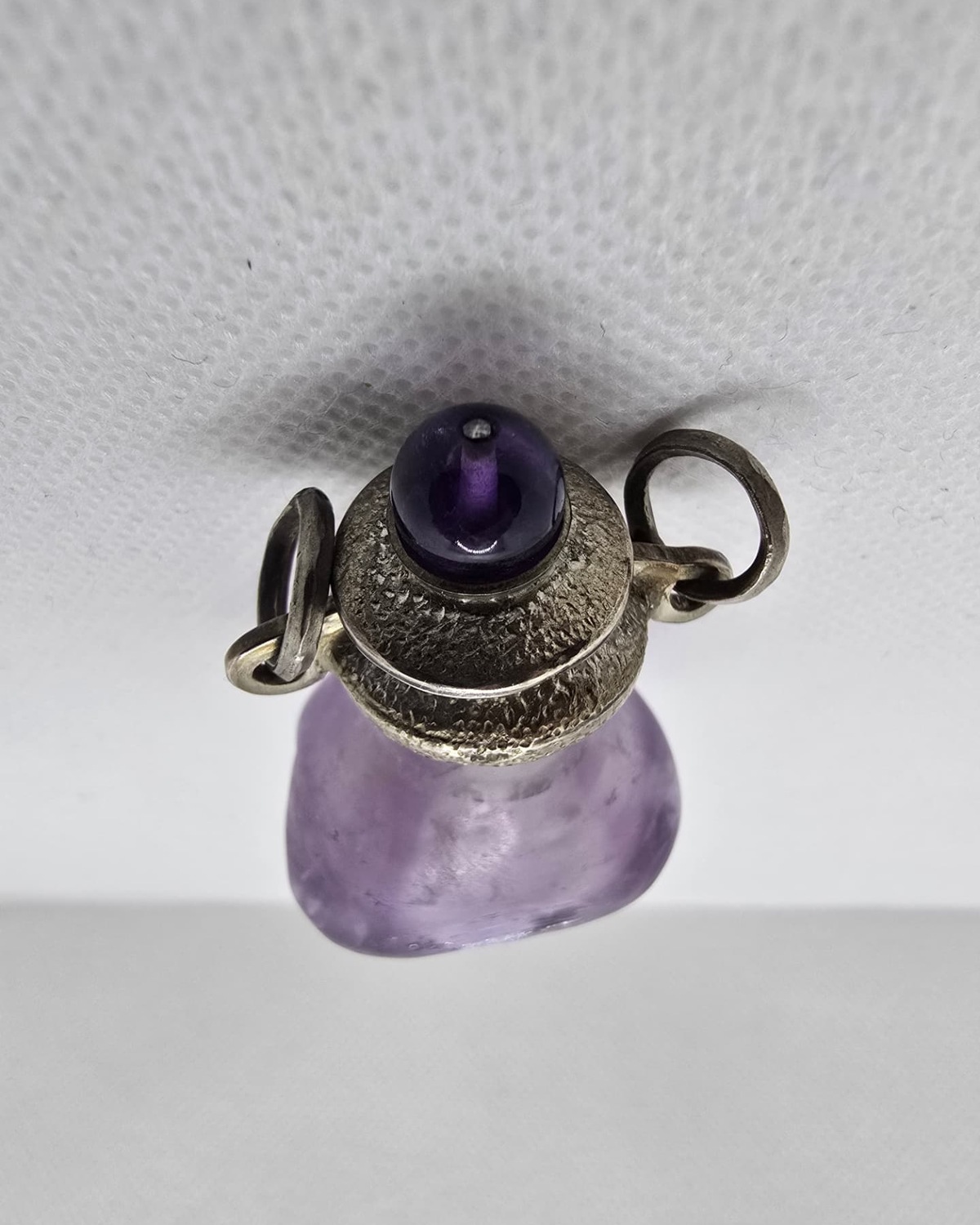 Frosted amethyst amphora, silver collar and cabochon stopper from above