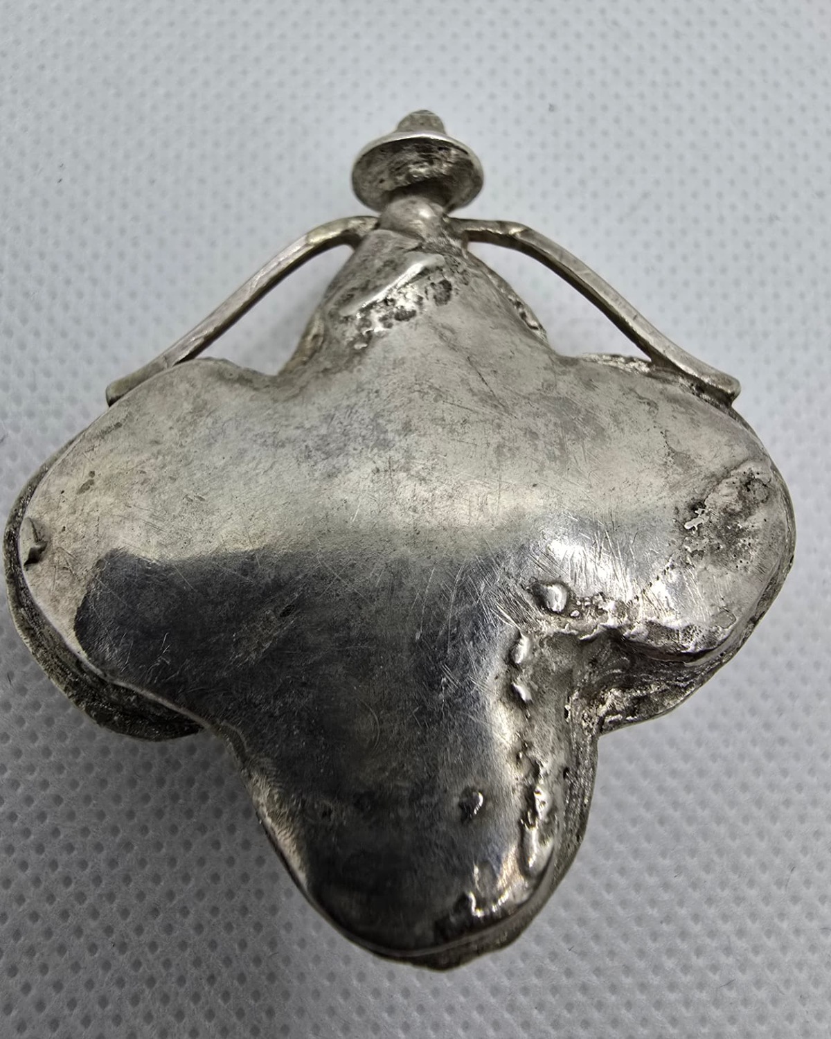 Mother-of-pearl petal vessel, silver reverse with hand-formed cradle and stopper