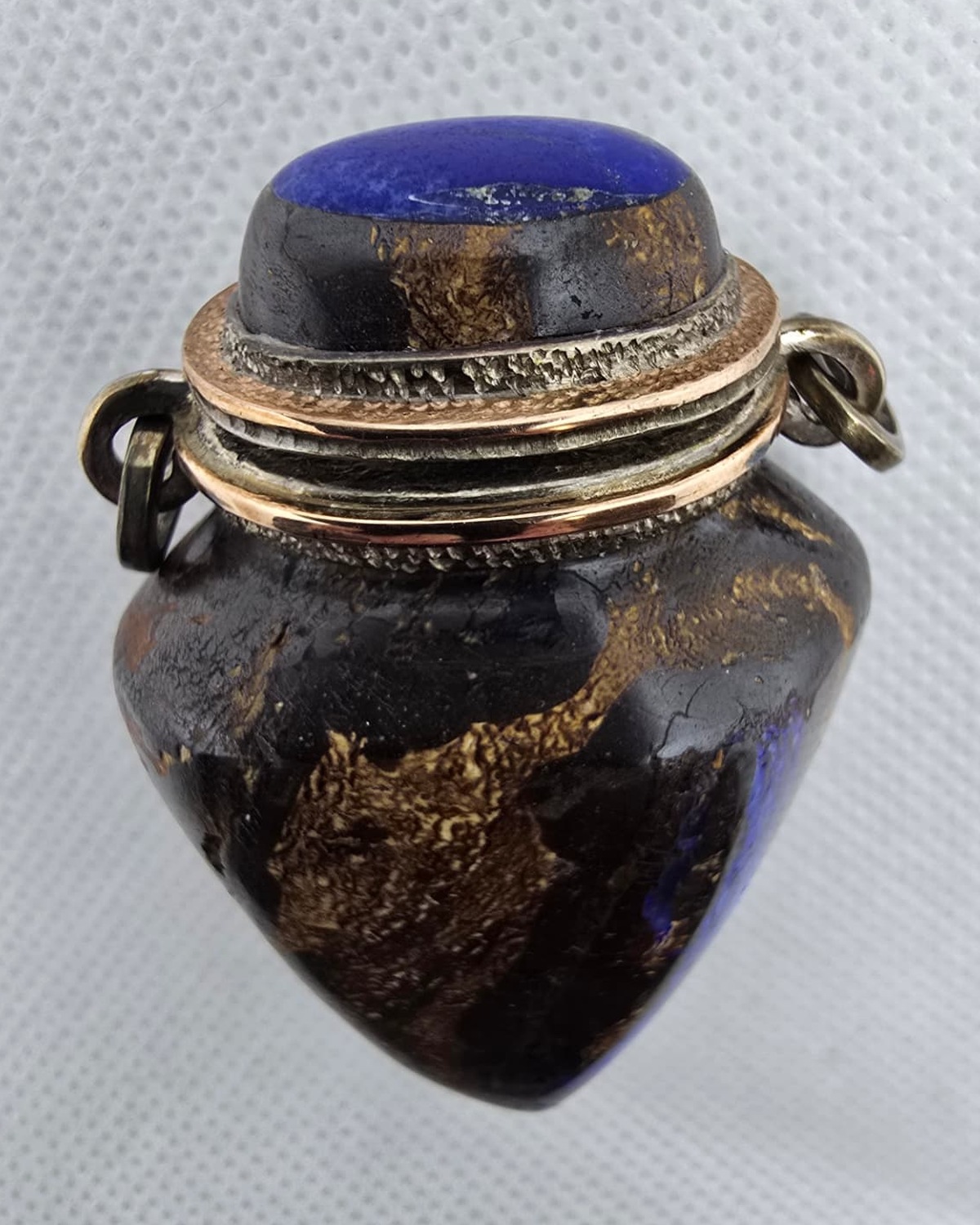 Dark gold-veined stone amphora vessel, neck and lapis stopper detail