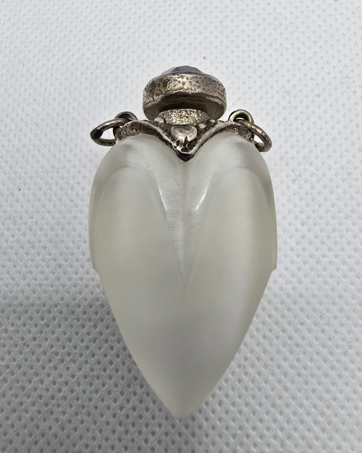 Frosted lobed quartz vessel with silver collar and amethyst stopper, front view