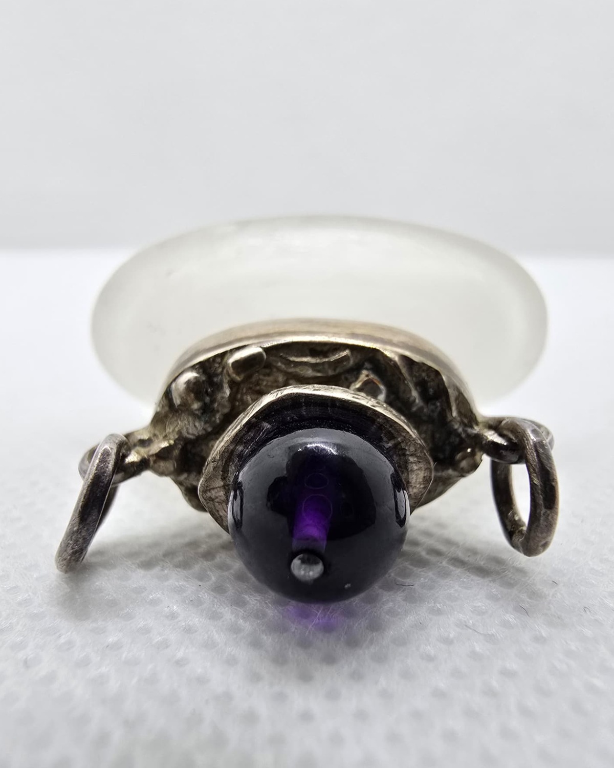 Amethyst cabochon stopper and chased silver collar seen from above
