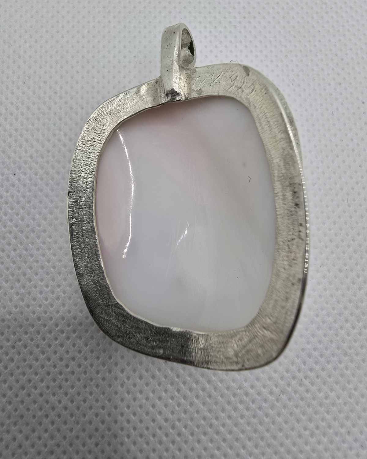 Serenity — reverse showing the natural shell within the broad handmade silver surround and pendant bail