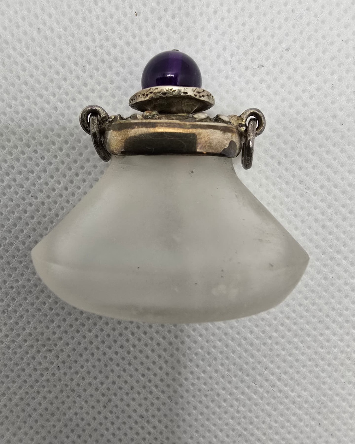 Frosted rock crystal flask with silver collar and amethyst cabochon stopper, front view
