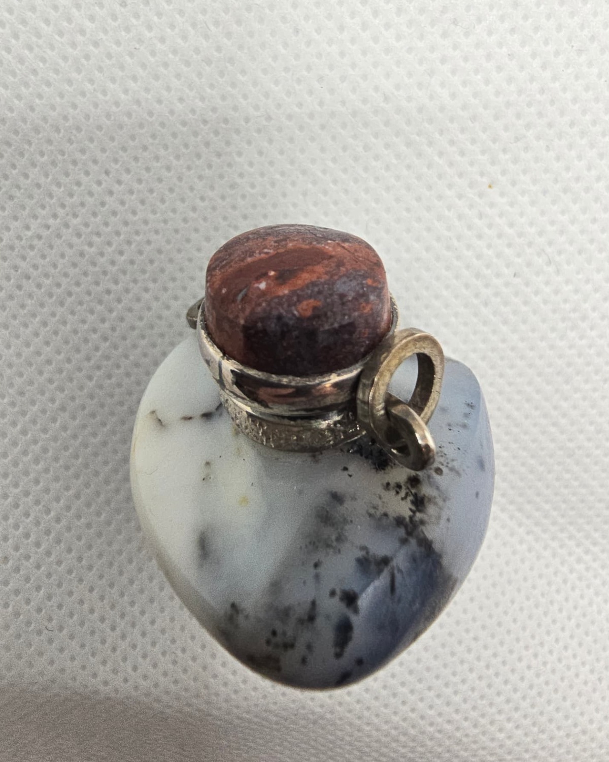 Heart-shaped dendritic agate vessel from above, silver collar and cabochon stopper