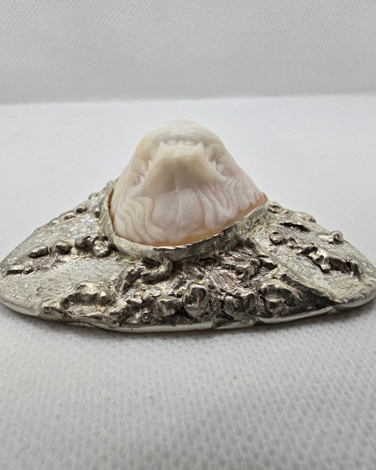 Lionheart — low-angle view showing the lion's muzzle, mouth and mane rising well above the surrounding shell and silver