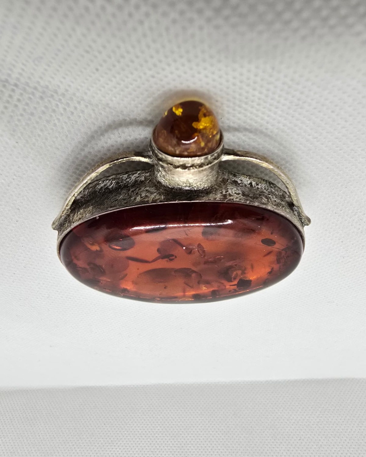 Amber and silver flask seen from above, silver collar and stopper