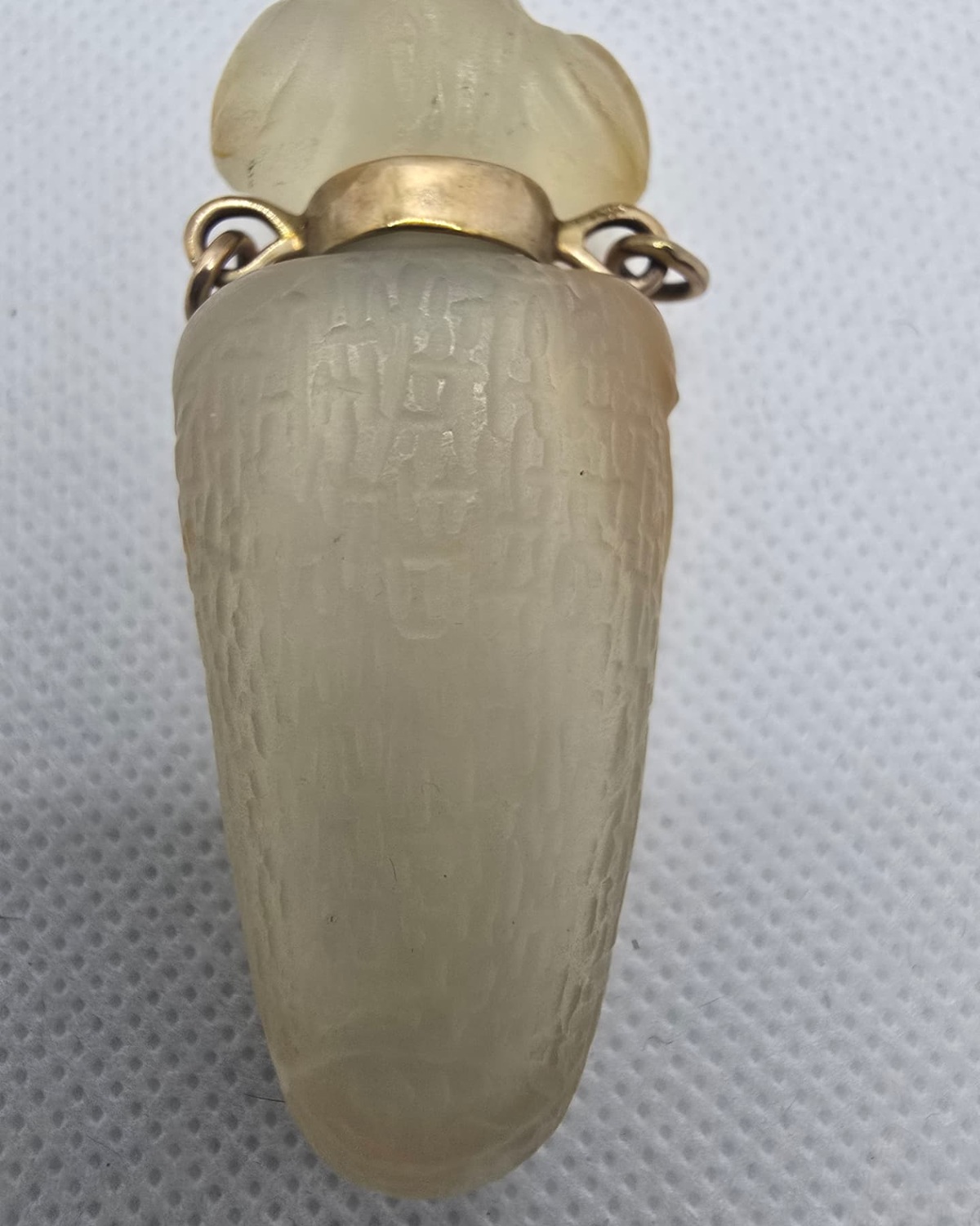 Pale jade vessel with incised surface carving, reverse view