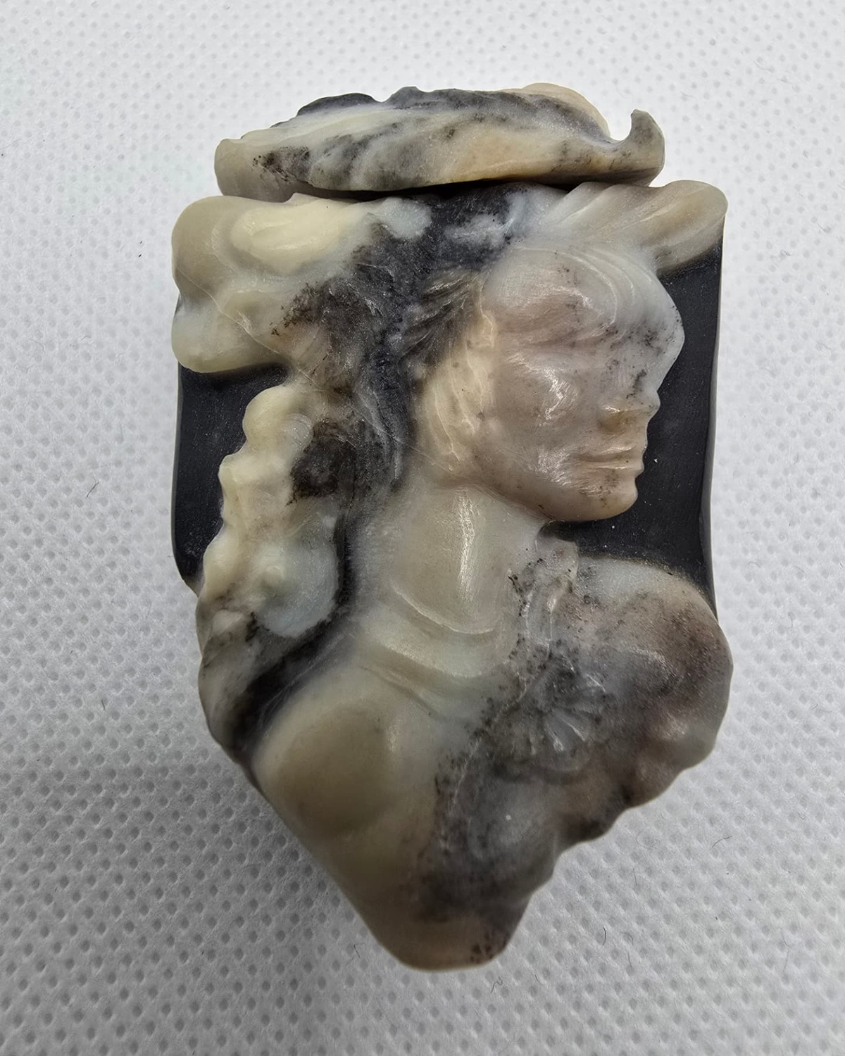 Carved cameo plaque vessel in banded black and cream agate, front view