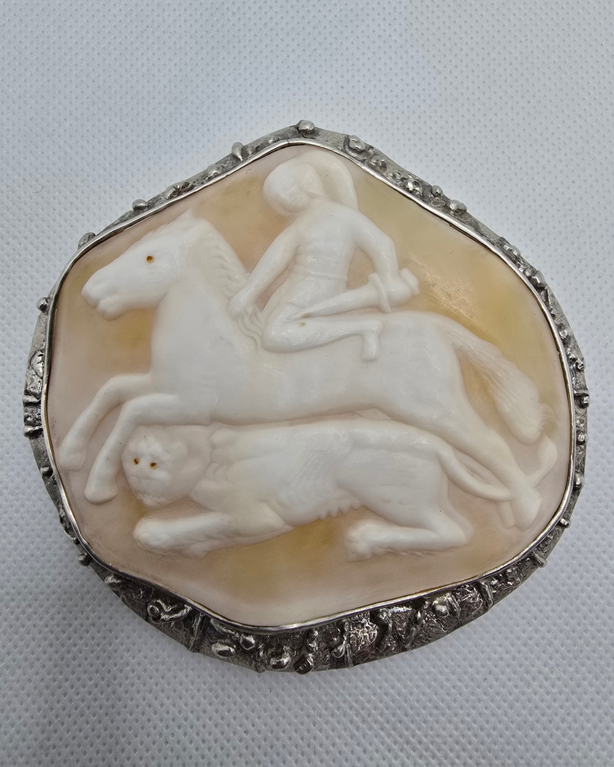 The Hunt — hand-carved shell cameo showing a mounted rider, horse in motion and running hound in pale relief