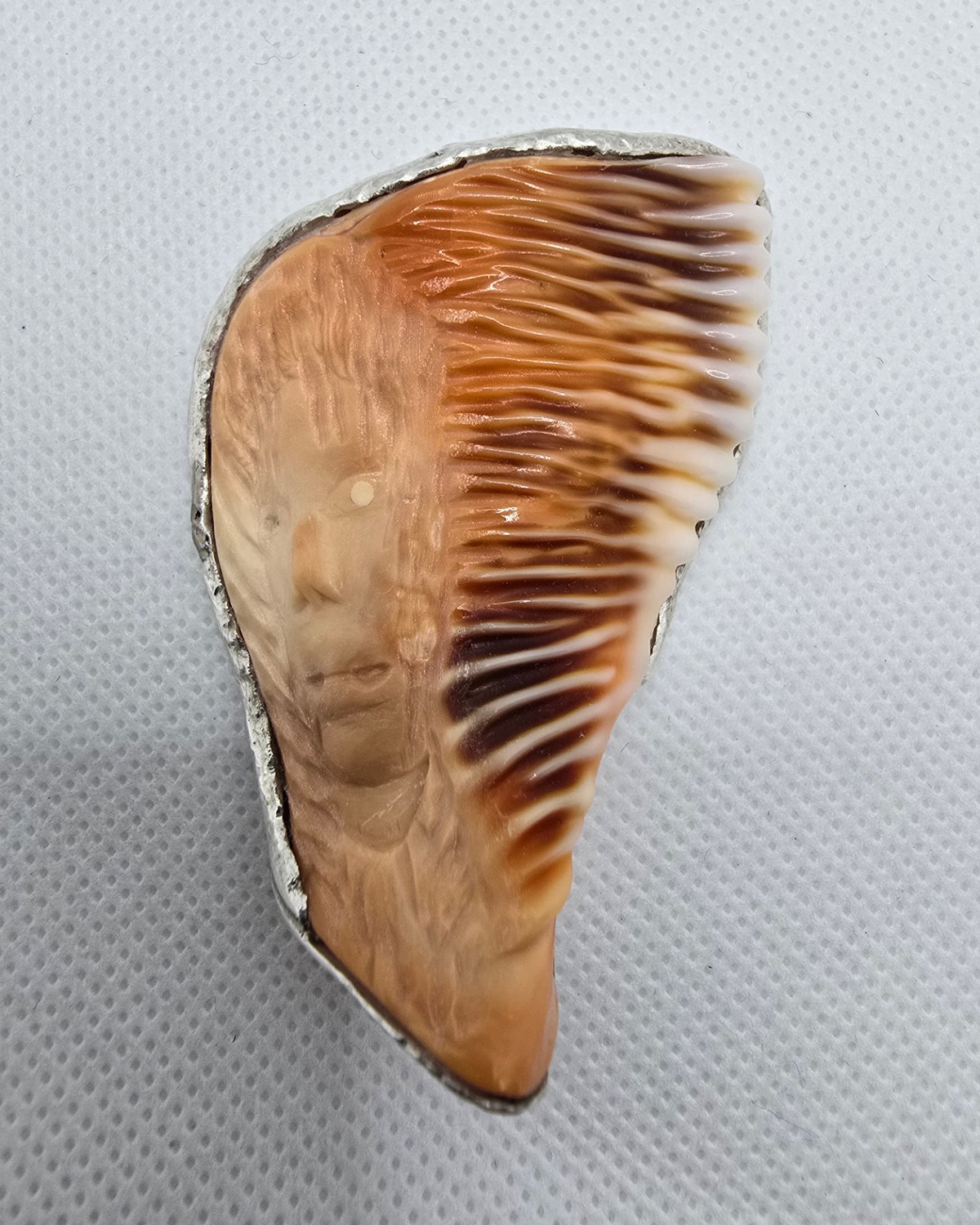 Spirit of the Chief — alternate front view showing the carved portrait and ribbed shell frame