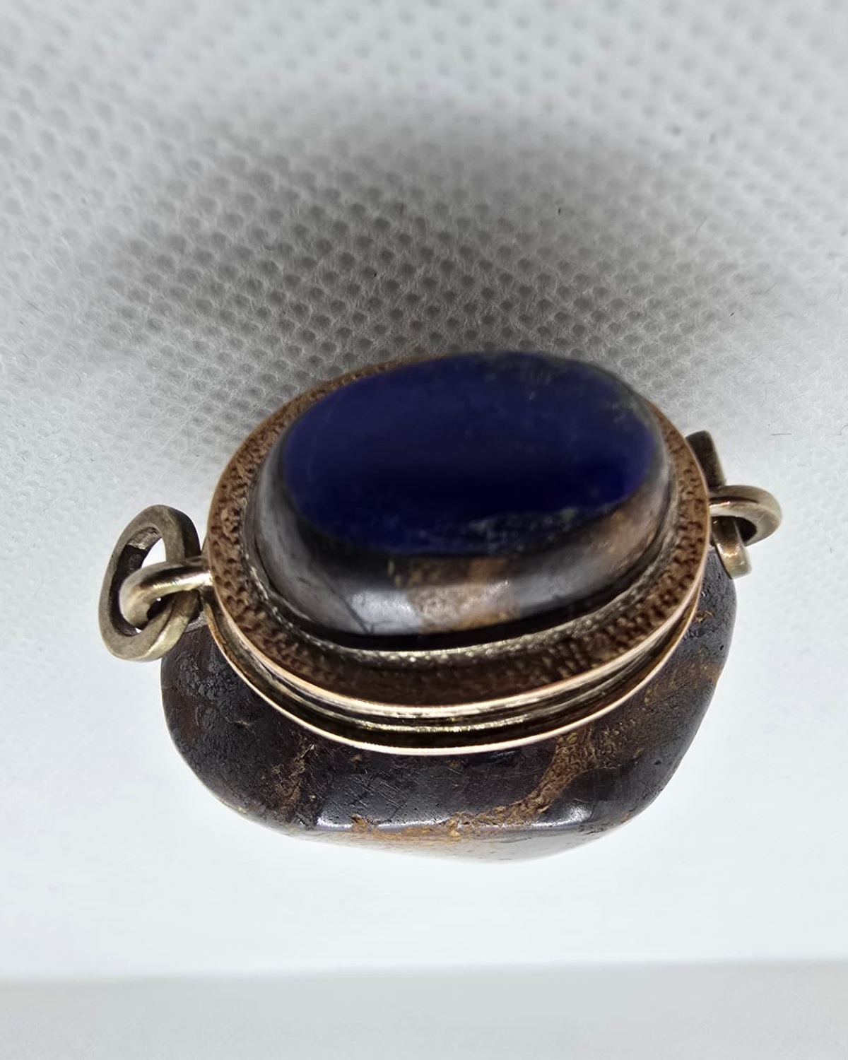 Dark gold-veined stone amphora vessel, lapis lazuli stopper from above