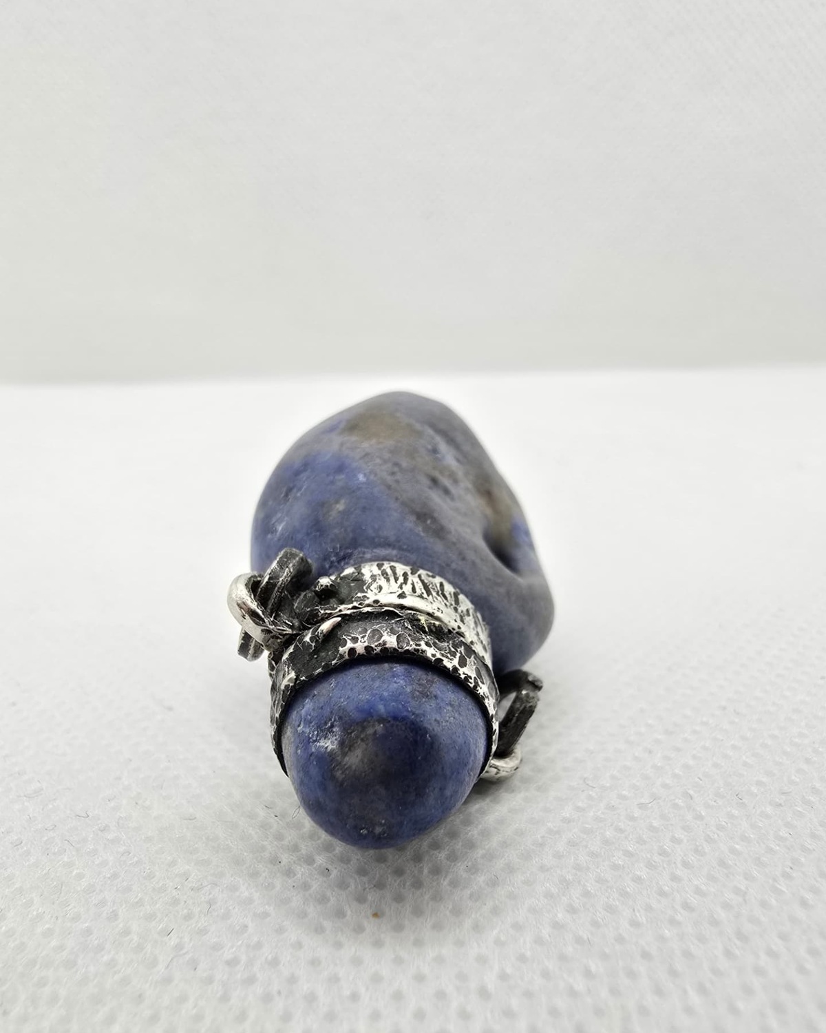 Blue sodalite pebble vessel, profile view