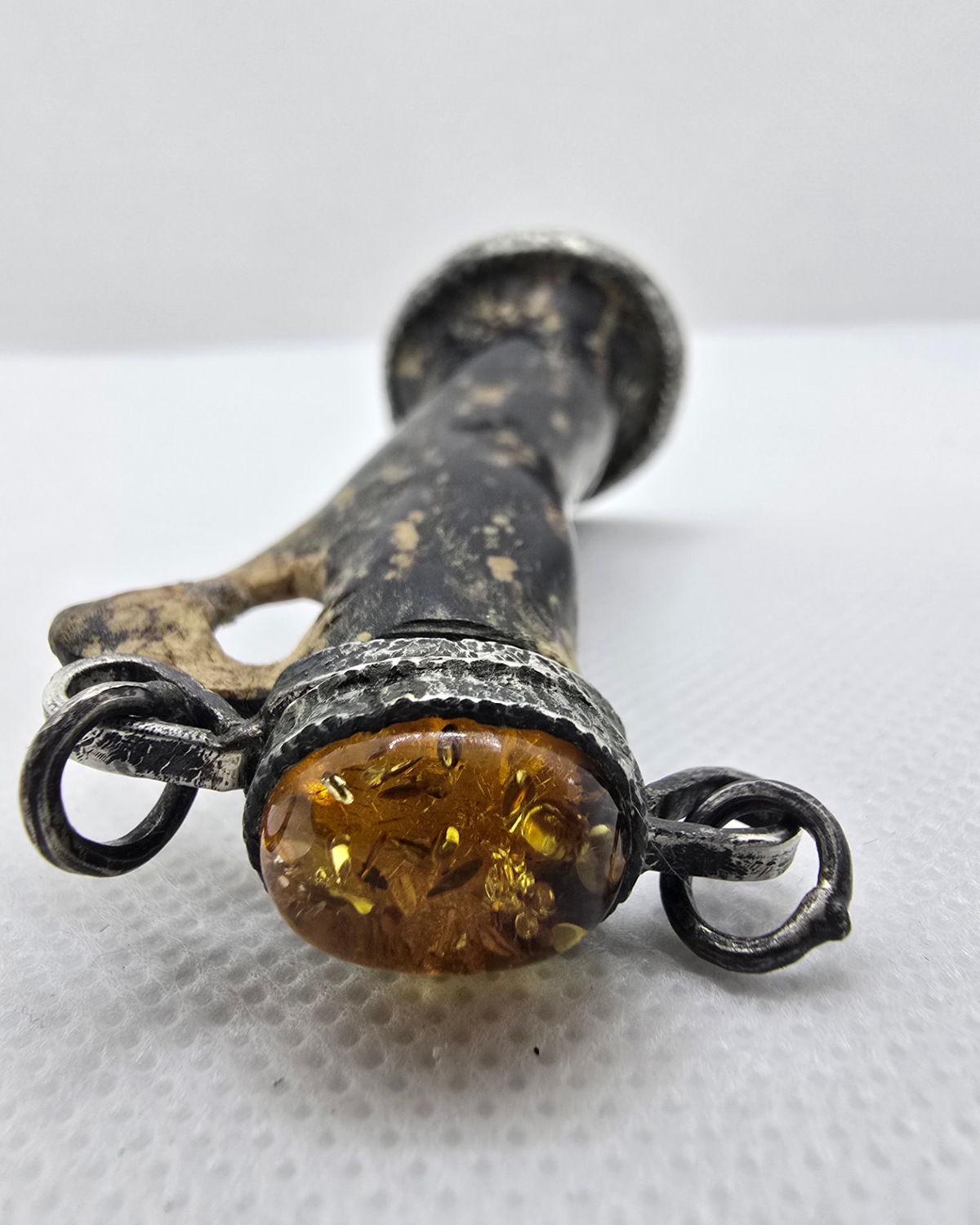 Carved antler vessel, Baltic amber cabochon stopper and silver scrollwork detail