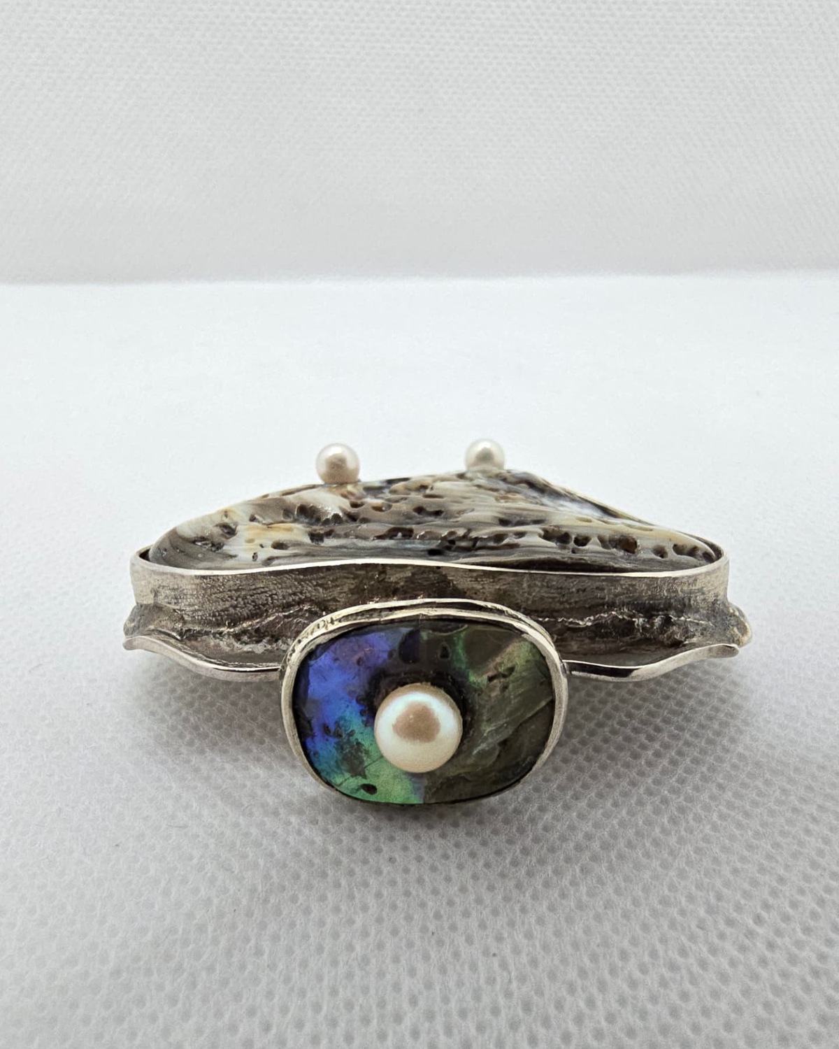 Abalone shell heart vessel with pearls, angled view
