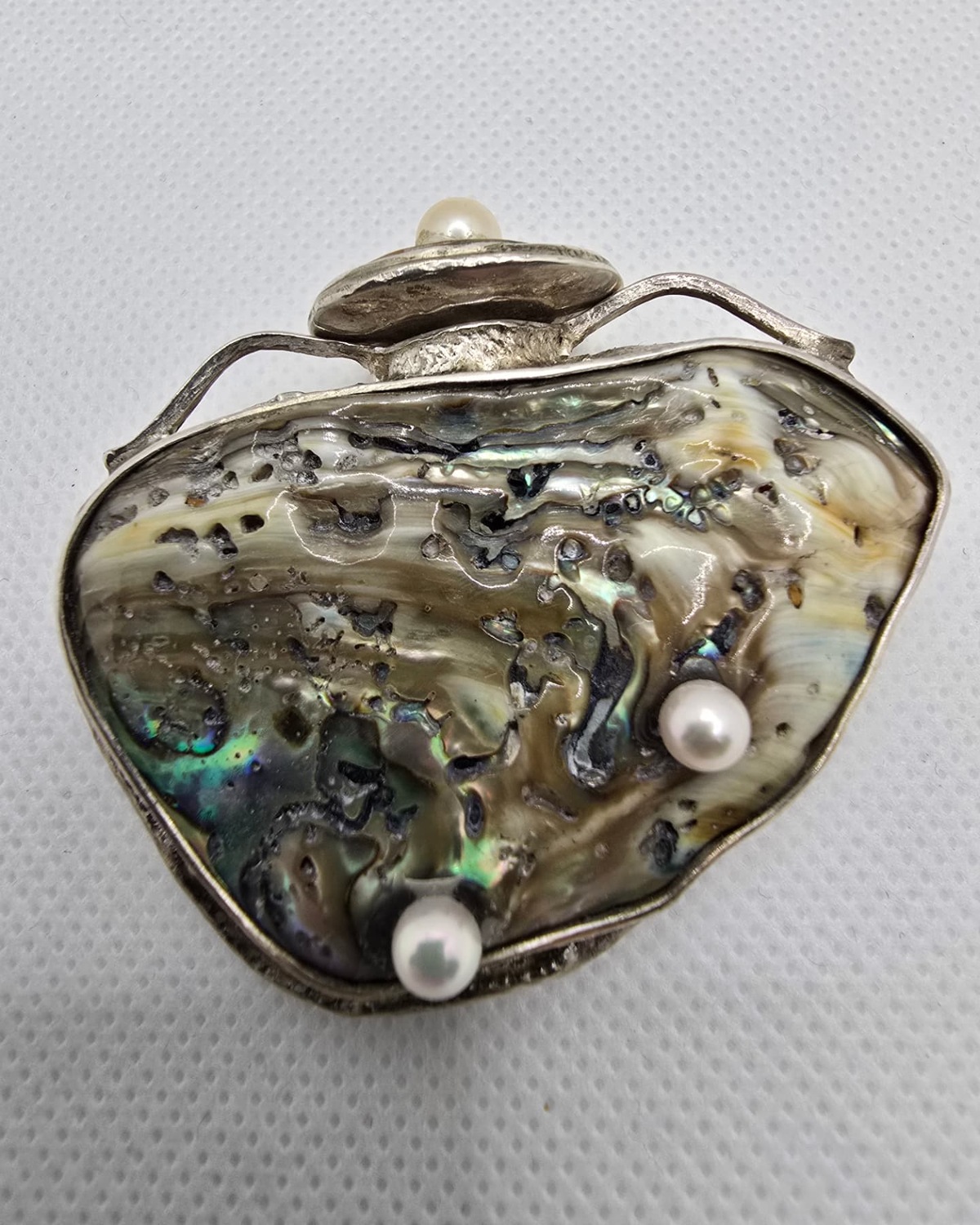 Abalone shell heart vessel set in silver with three pearls, front view
